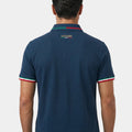 Man wearing a navy blue polo shirt with 'Azzurri' branding on the back against a white background