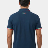 Man wearing a navy blue polo shirt with 'Azzurri' branding on the back against a white background