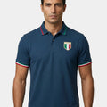 Man wearing a navy blue polo shirt with a logo on a white background