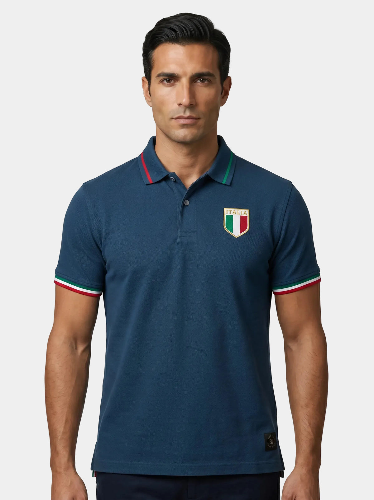 Man wearing a navy blue polo shirt with a logo on a white background