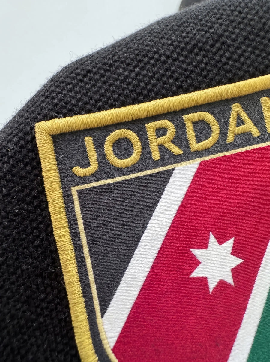 Jordan Al Nashama Polo Shirt — badge close-up detail