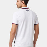 Man wearing a white polo shirt with 'USA' logo on the back against a light background