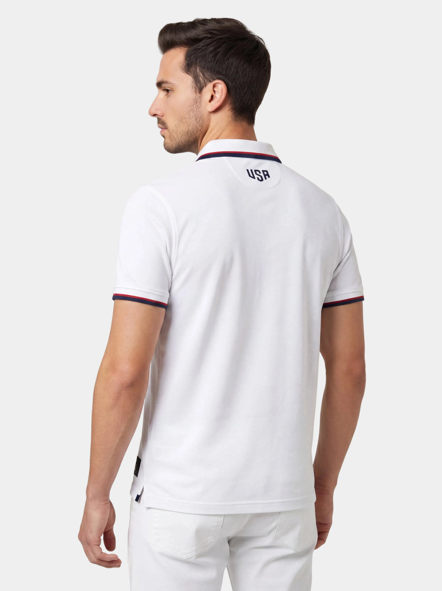 Man wearing a white polo shirt with 'USA' logo on the back against a light background
